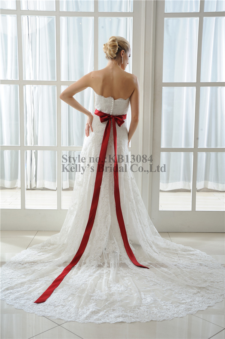 wedding dress with large red ribbon