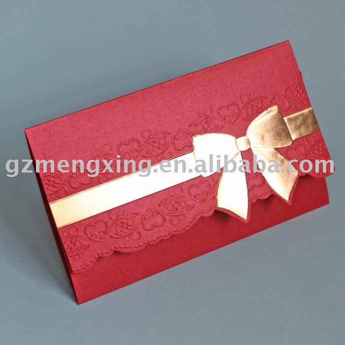 Wedding invitation card with golden ribbon bow surrounding pretty patterns