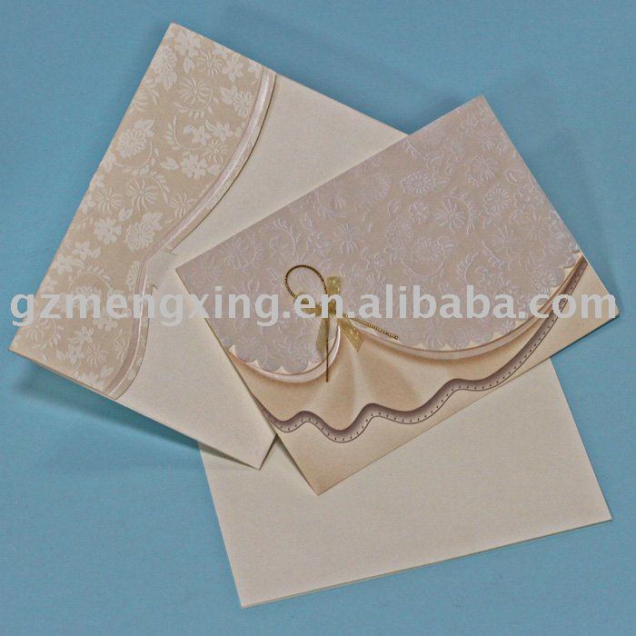 Wedding invitation card with a fancy flowers tied with lovely ribbon bow and