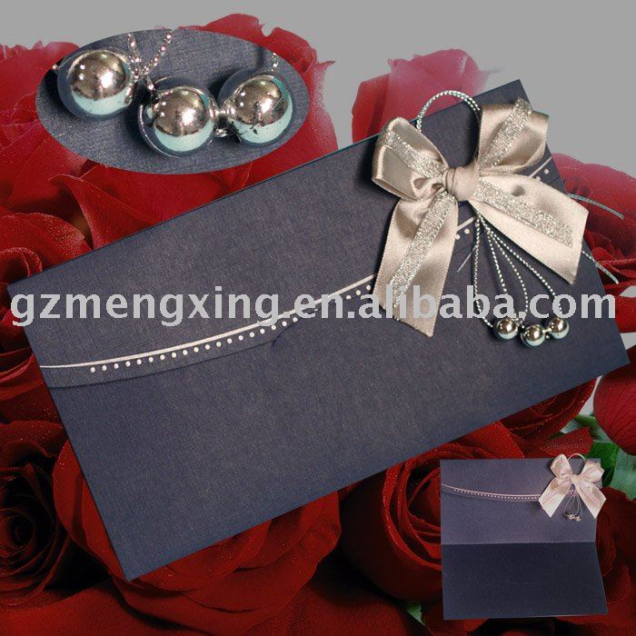 Wedding invitation card with great silver ribbon bow attaching silver pearl